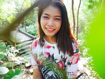 Portrait of smiling young woman at park