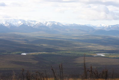 Scenic view of mountains against cloudy sky