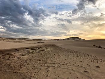 Scenic view of desert against sky during sunset