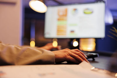 Cropped hand of businessman working on table