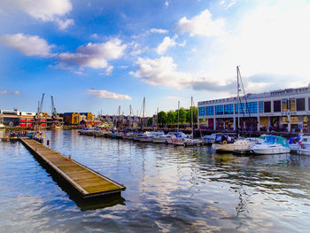 Sailboats moored in harbor