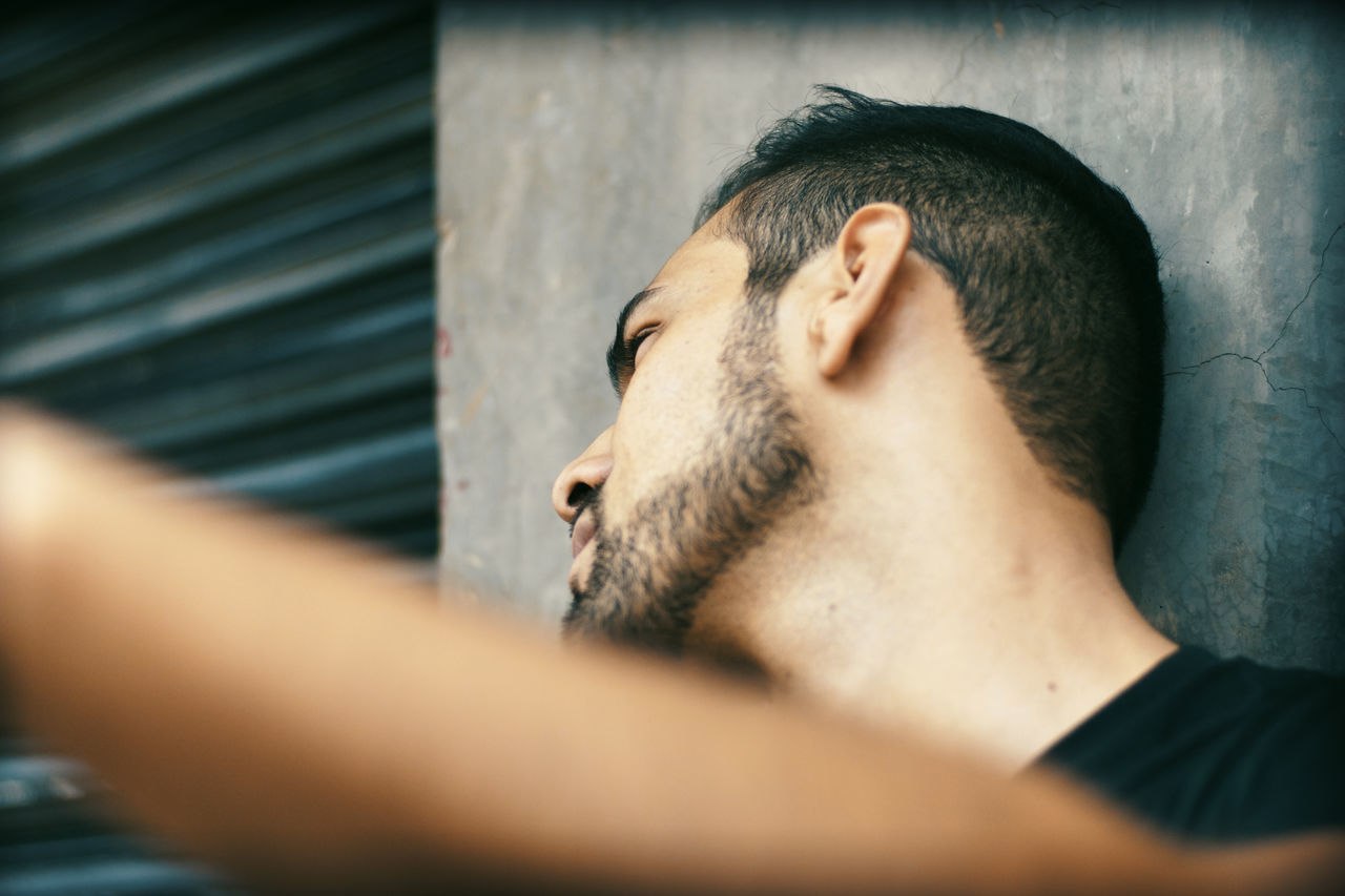 MAN WITH DOG AGAINST BLURRED BACKGROUND