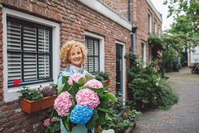 Portrait of woman holding flowers