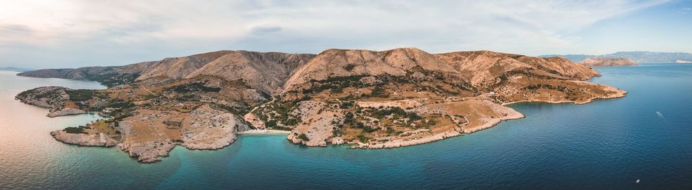 Scenic view of rock formation in sea against sky