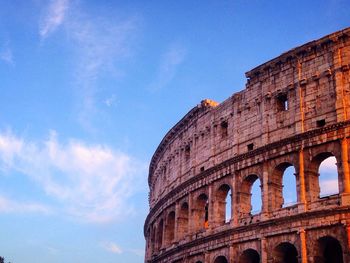 Low angle view of coliseum against sky