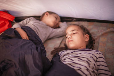 High angle view of people sleeping on bed