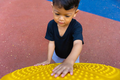 High angle view of boy playing with outdoor play equipment