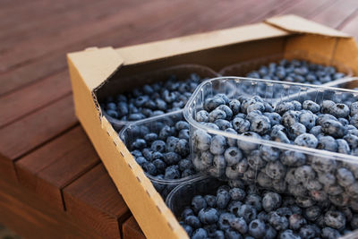 Box, crate or container with collected fresh blueberries. berries agriculture business