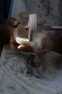 Midsection of worker working in factory