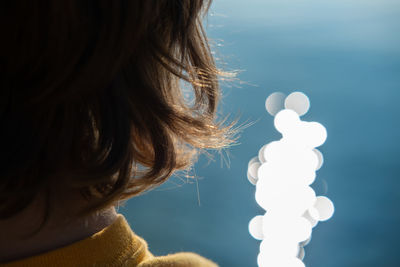 Close-up of boy standing by lake