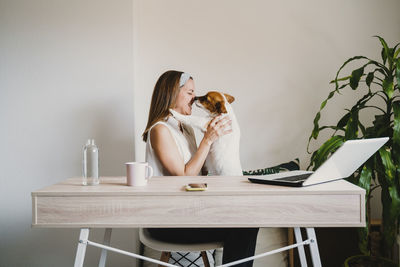 Woman sitting on table