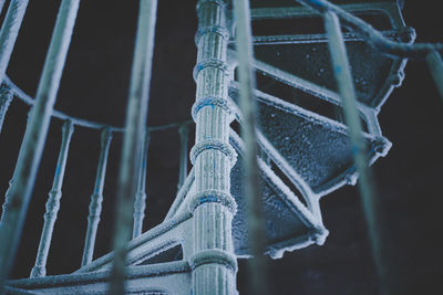 Low angle view of frozen spiral staircase during winter at night