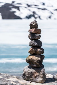 Stack of stones on rock at beach