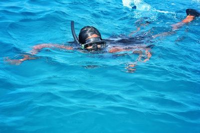 High angle view of teenage girl swimming in sea