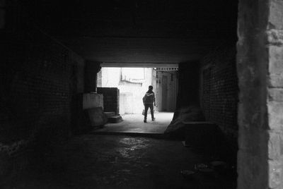 Full length of woman walking in tunnel