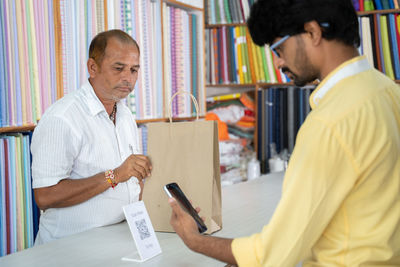 Side view of a man using smart phone