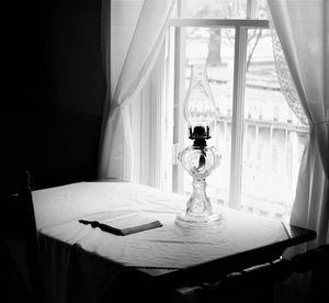 Close-up of electric lamp on bed at home