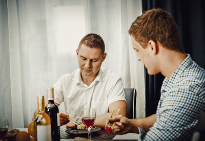 Young man and woman sitting at table