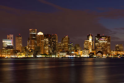 Illuminated buildings against sky at night