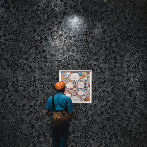 Rear view of man standing against wall