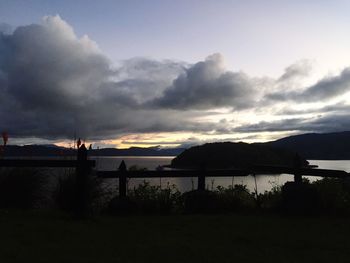 Scenic view of lake against cloudy sky