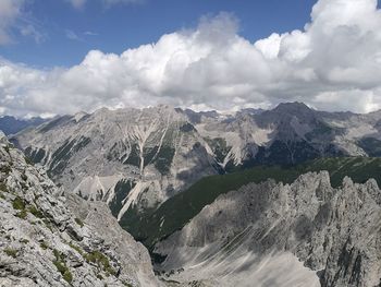 Scenic view of mountains against cloudy sky