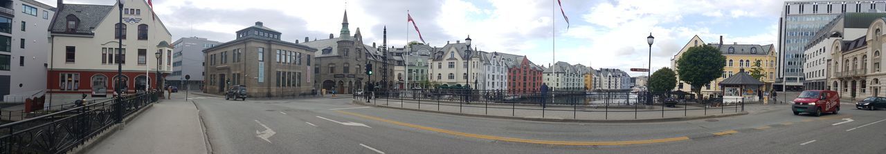 Panoramic view of city street against sky