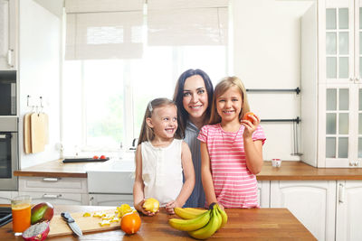 Portrait of smiling with daughters at home