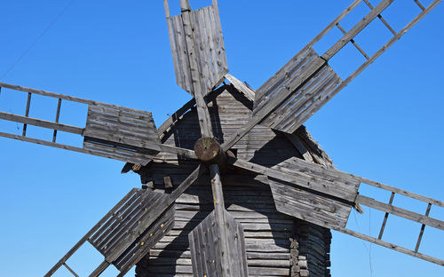 High section of windmill against clear blue sky