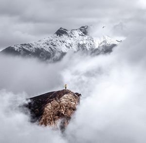 Scenic view of snowcapped mountain against cloudy sky