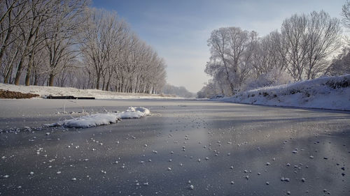 View of frozen lake against sky during winter