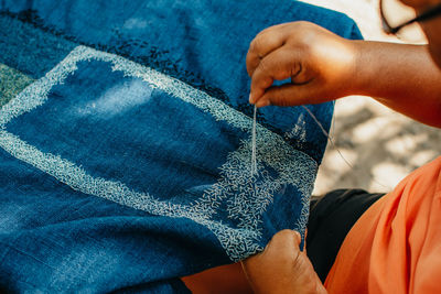 High angle view of man legs against blue wall