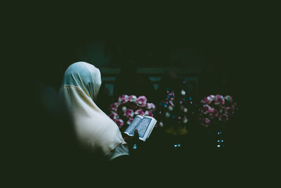 Woman wearing hijab reading koran