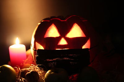 Close-up of lit candles in the dark