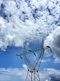 Low angle view of electricity pylon against sky