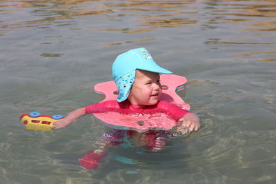 Cute girl floating in lake