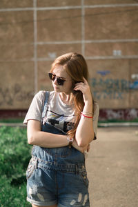 Young woman wearing sunglasses standing outdoors