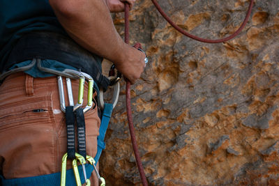 Low section of man standing on rock