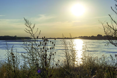Scenic view of lake against sky during sunset