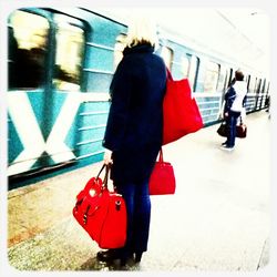 Full length of woman standing on railing