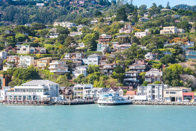 Aerial view of city by sea