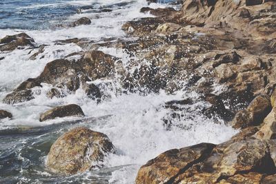 Scenic view of sea by rocks