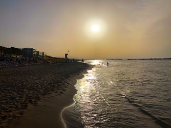 Scenic view of beach against sky during sunset