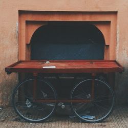 Bicycles parked against brick wall