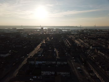 High angle view of buildings in city during sunset