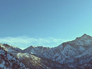 Scenic view of mountains against blue sky