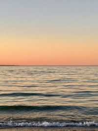 Scenic view of sea against clear sky during sunset