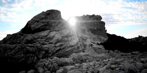 Low angle view of rock formation against sky