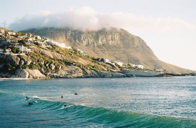 Scenic view of sea and mountains against sky