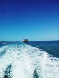 Scenic view of sea against clear blue sky